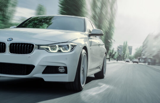 Saratov, Russia - May 07, 2017: White BMW 3 Series F30 car is driving on asphalt road at summer daytime