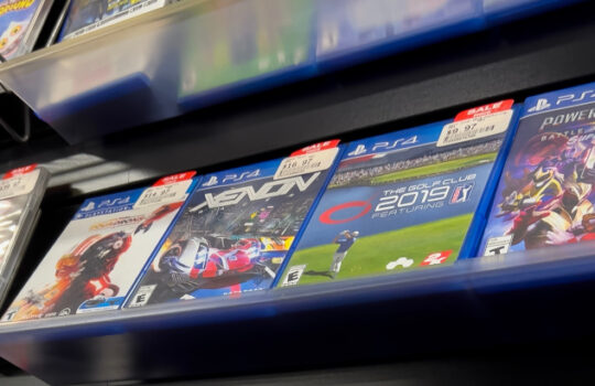 Seattle, WA USA - circa December 2022: Selective focus on used video games for sale inside a GameStop gaming store.