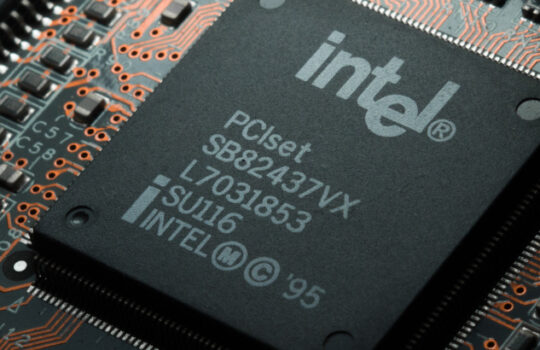 Russia, Berdsk - 17 feb 2021: Intel computing chip on an old motherboard. Old electronics close-up. Chip ICS. Electronic background. Selective focus.