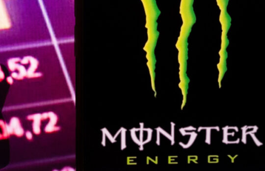 KONSKIE, POLAND - August 30, 2022: Smartphone displaying logo of Monster Beverage company on stock exchange diagram background