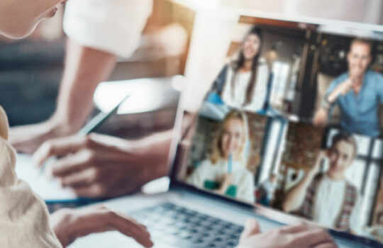 Office business team concept. Video conference using laptop with remote working teammates. Wide screen orientation