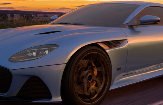 Aston Martin DBS superleggera on a scenic road at sunset