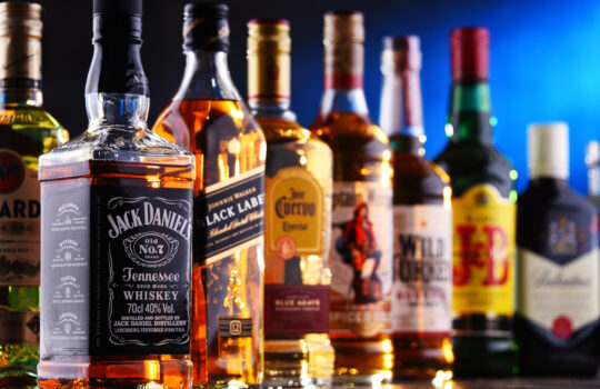 Bottles of assorted global liquor brands including whiskey, vodka, gin and liqueur