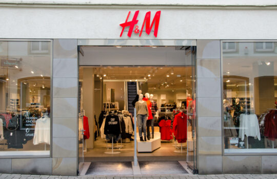 Soest, Germany - December 18, 2017: H&M sign on the wall. H&M Hennes & Mauritz AB is a Swedish multinational clothing-retail company, clothing for men, women, teenagers and children.