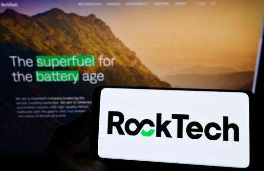 Stuttgart, Germany - 01-06-2022: Person holding smartphone with logo of Canadian mining company Rock Tech Lithium Inc. on screen in front of website. Focus on phone display.