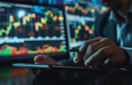 A businessman studying stock market trends and gold prices on a digital tablet, making informed financial decisions for investment portfolios.