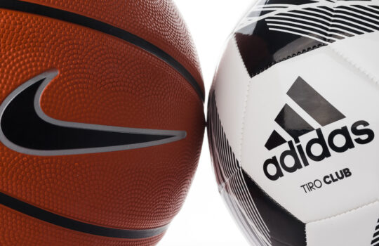 Adidas and Nike brand balls. Basketball and soccer balls on a white background. Adidas football and Nike basketball.