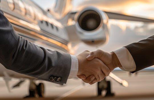 Business handshake in front of a private jet. Concept of successful partnership, deal, corporate travel, and executive agreement.