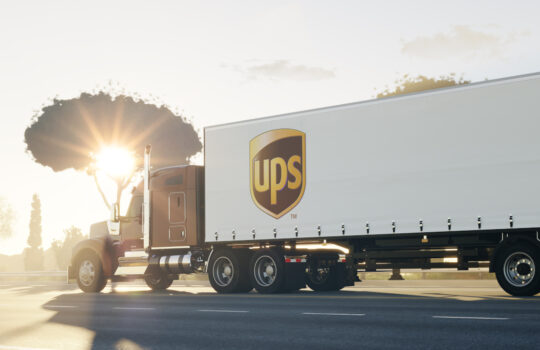 Guilherand-Granges, France - October 12, 2021. Truck on road with UPS logo. American multinational package delivery and supply chain management company. 3D rendering.