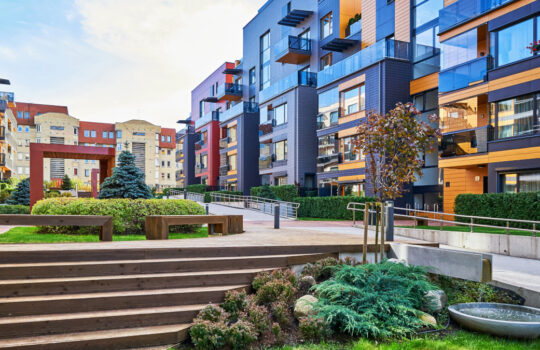 Modern complex of apartment residential buildings. With staircase, fountain, and other outdoor facilities.
