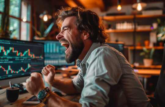 Successful Stock Market Day Trader Analyzing Real-Time Investment Charts on Multi-Monitor Workstation. Trader and business concept