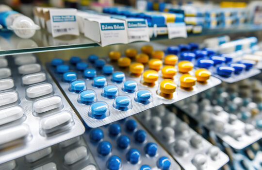 Pharmacy with shelves, with different types of pills. pharmaceutical industry, rising prices of drugs, drug production, shortage of drugs in pharmacies