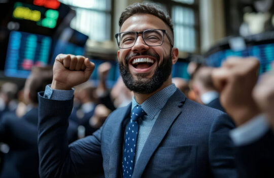 Joyful business professional celebrating a successful day at the stock market.