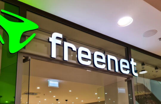 Kiel, Germany - 19. April 2025: Illuminated Freenet sign at the entrance of a store selling mobile and internet services