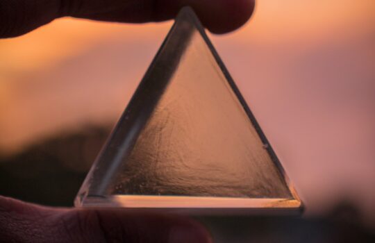 person holding triangle glass panel