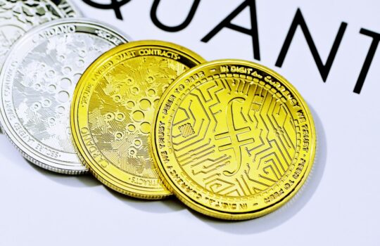 a close up of five different colored coins