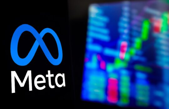Meta logo in blue infinity symbol with the word Meta beside a blurred colorful stock chart on the right.