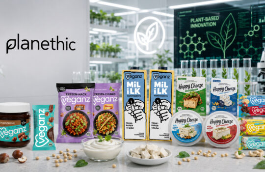 Assortment of vegan snacks and dairy alternatives on a lab counter with 'planethic' branding in the background
