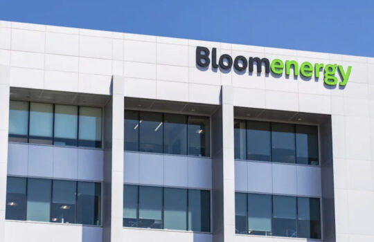 Exterior of Bloom Energy office building with the blue-green Bloom Energy logo on a white facade.
