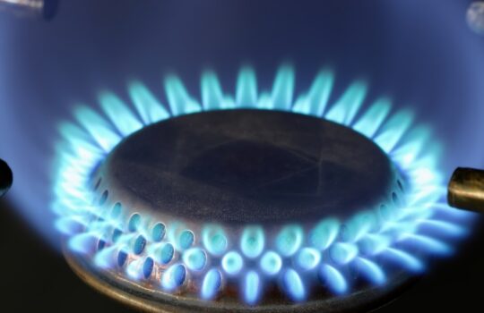 A close up of a blue flame on a stove