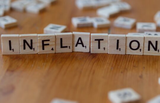 Inflation is spelled out using scrabble tiles.