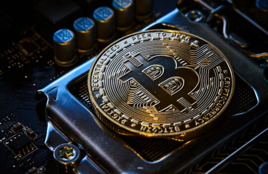 a bitcoin on top of a computer motherboard