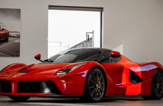 red ferrari 458 italia parked in front of white wall