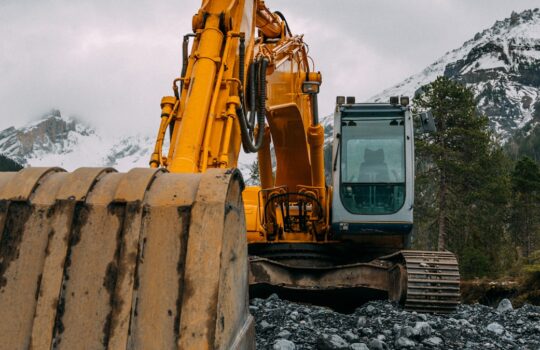 yellow and black heavy equipment on rocky ground