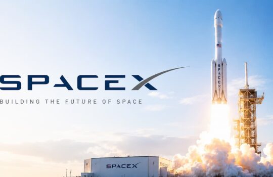 SpaceX rocket lifting off from a launch pad with a bright flame plume and ground facility branded SpaceX in the foreground.
