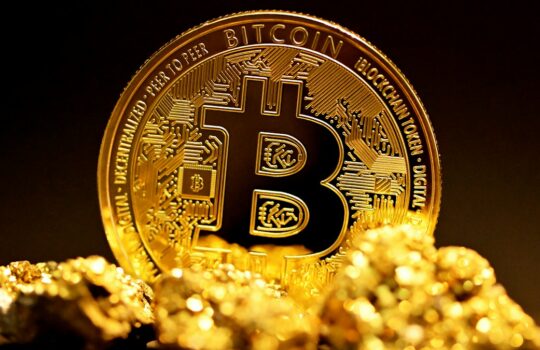 a bitcoin sitting on top of a pile of gold nuggets