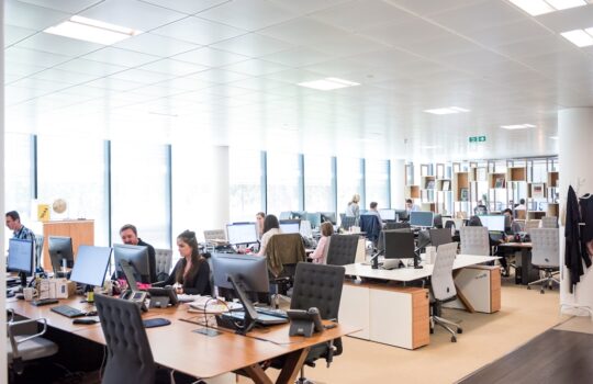 people working at desks in open office