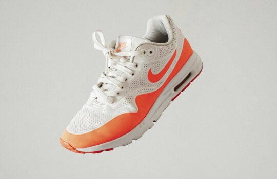 white and red nike athletic shoe