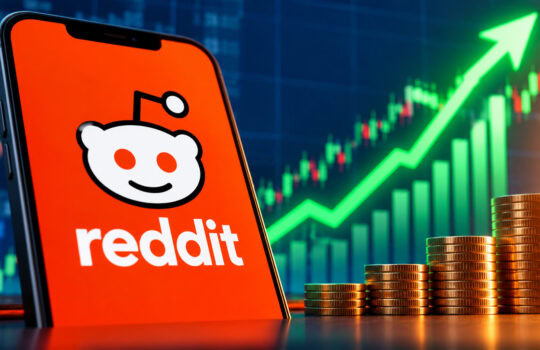 Reddit logo on a smartphone screen with a rising stock chart and stacked coins in the foreground, signaling financial growth.